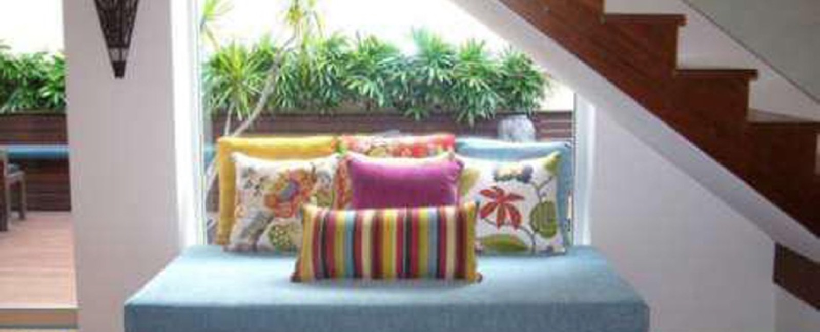 Colourful scatter cushions arranged on a window seat