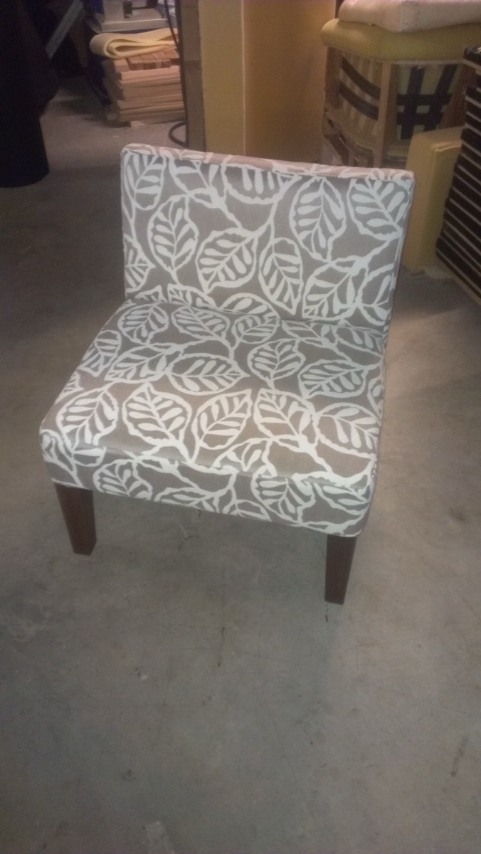 An occasional chair recovered in a grey and white leaf print