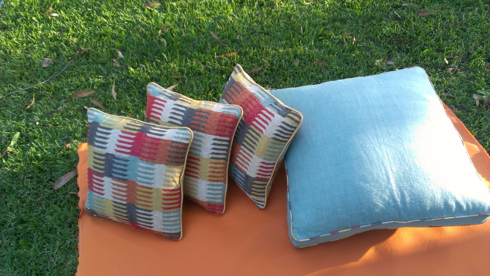 Custom outdoor scatter cushions on the lawn